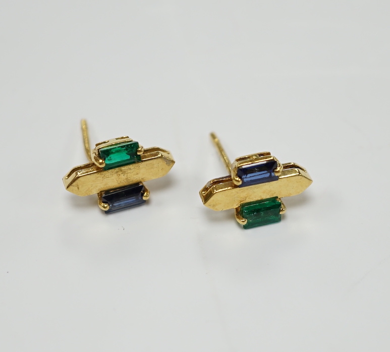A modern pair of 18t gold, two emerald and sapphire set ear studs, 12mm by 7mm, gross weight 3.3 grams.